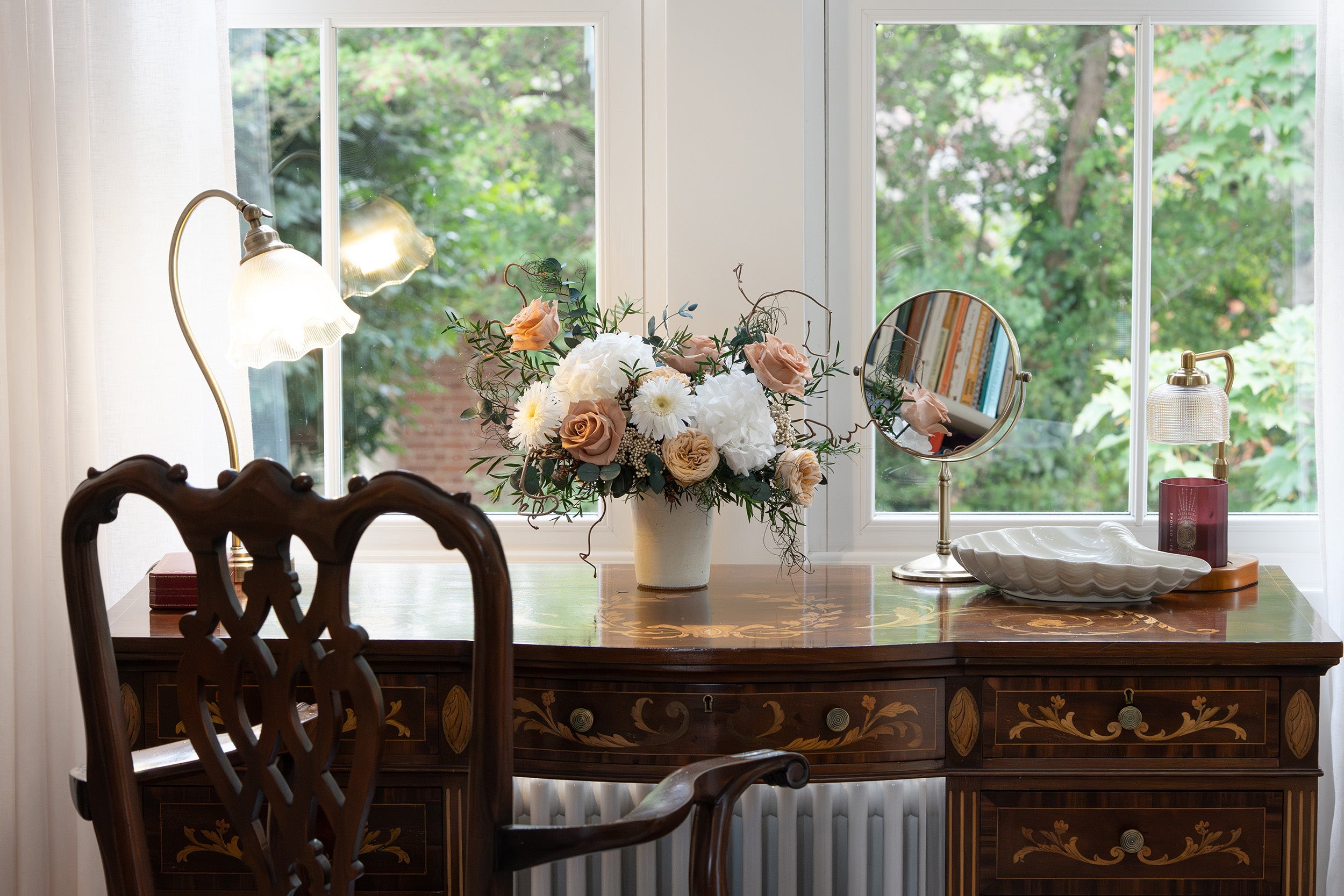 Preserve toffee and white mixed flowers arrangement on a writing desk