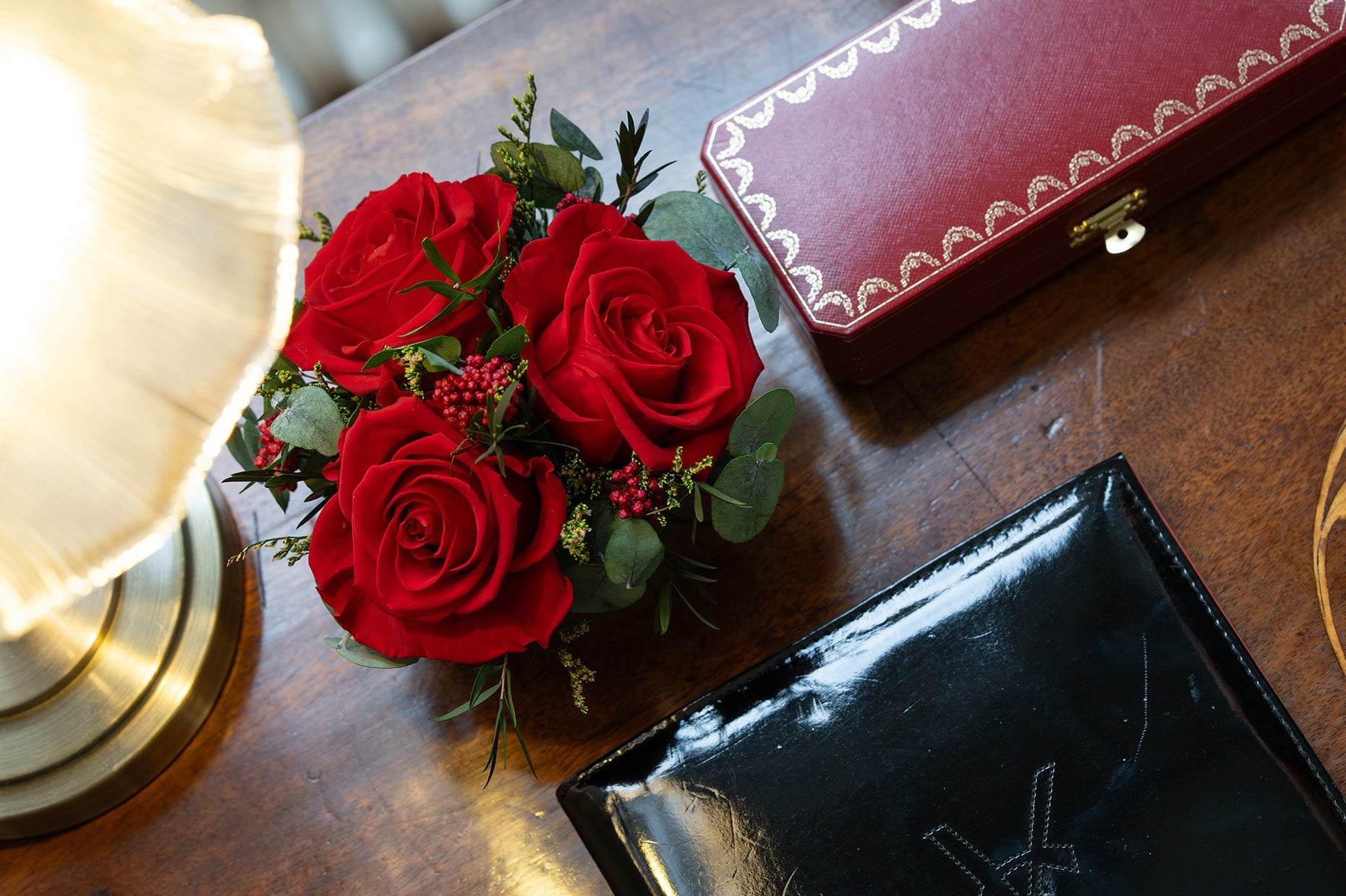 Red preserved roses arrangement in porcelain vase
