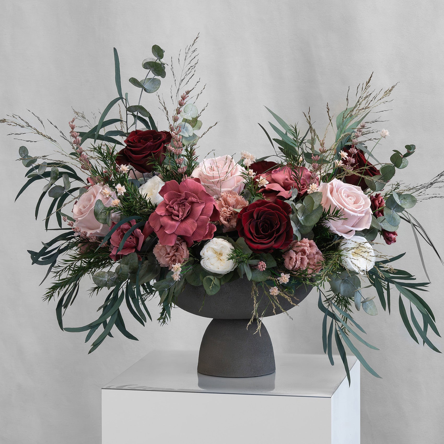 PRESERVED BURGUNDY & CHERRY MIXED FLOWER ARRANGEMENT IN GREY FOOTED VASE
