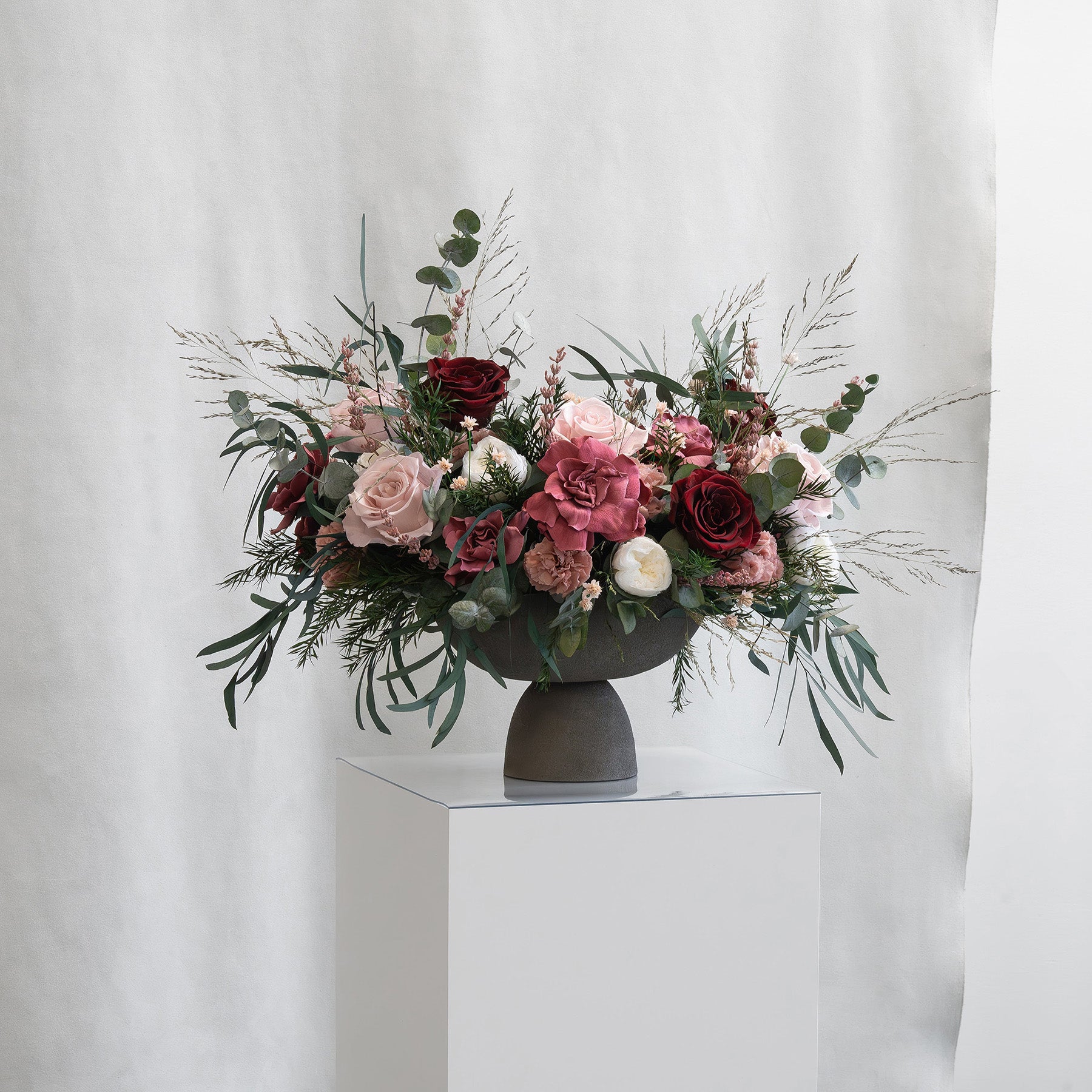 PRESERVED BURGUNDY & CHERRY MIXED FLOWER ARRANGEMENT IN GREY FOOTED VASE