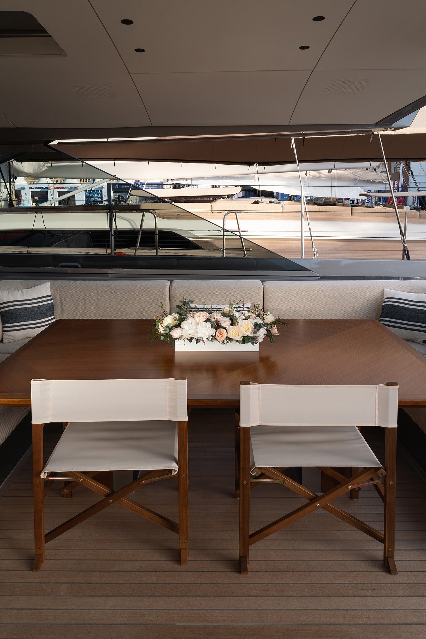Preserved mixed flowers arrangement in a long low vase on a sailing yacht