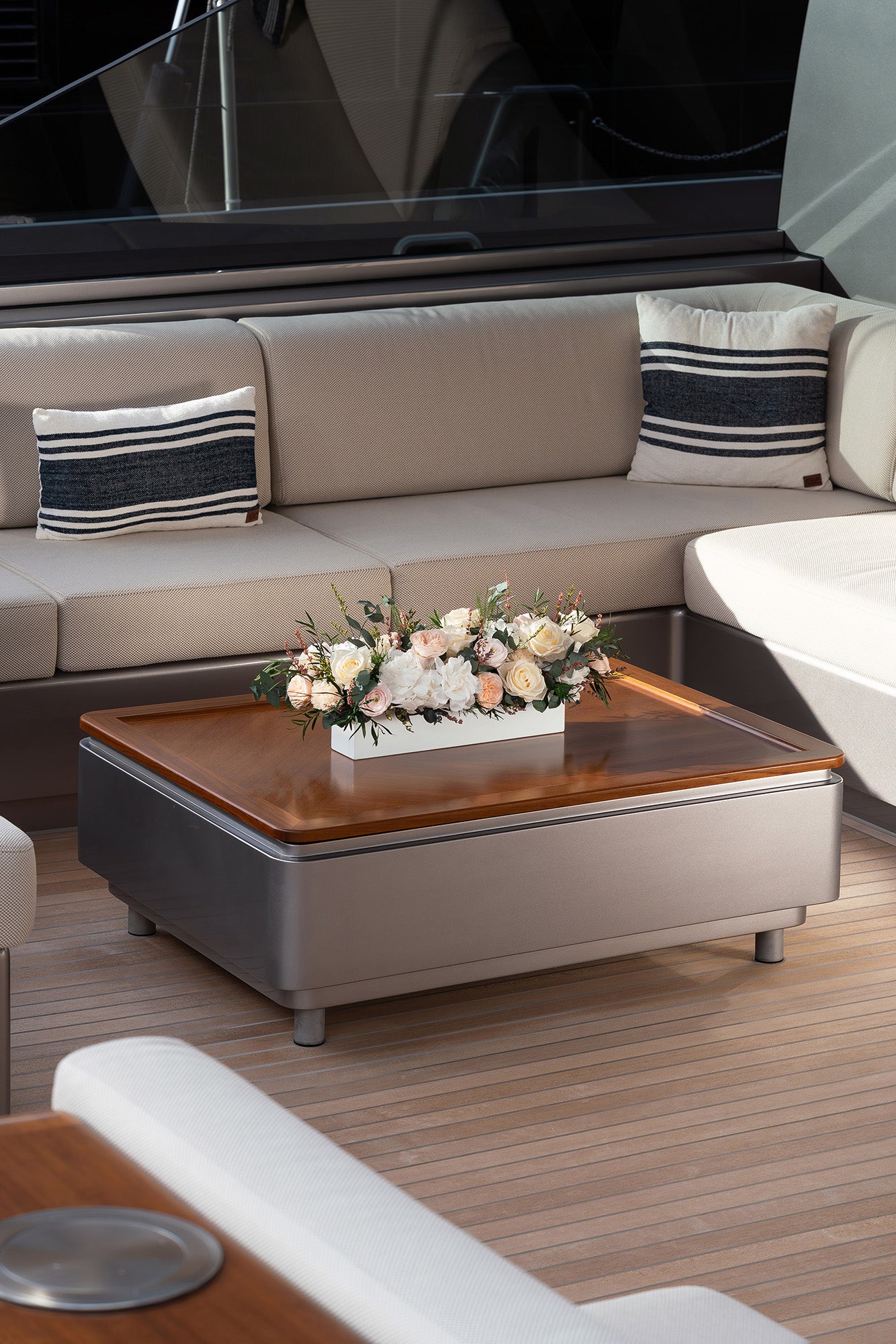 Preserved mixed flower arrangement in a long low vase on a sailing yacht