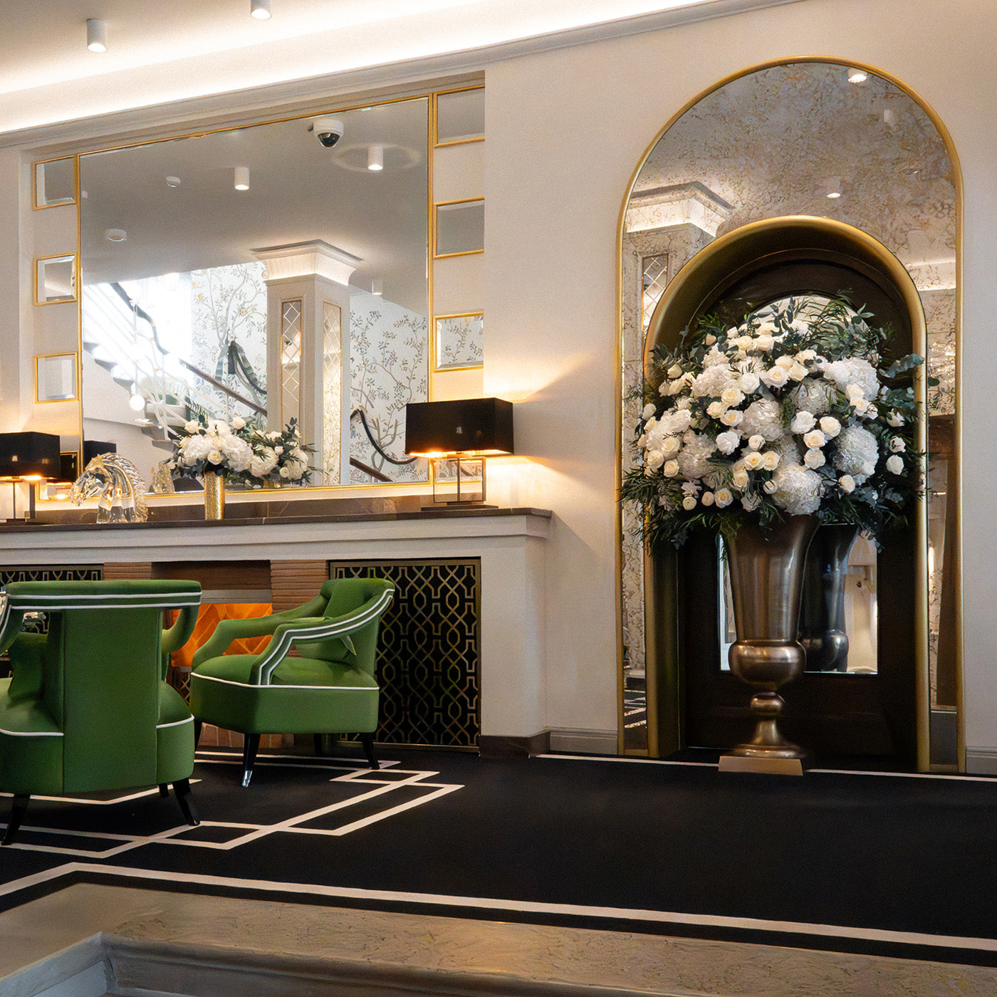 An elegant hotel lobby with a preserved floral arrangements. Featuring preserved white hydrangeas, preserved roses and peonies, finished with preserved eucalyptus.