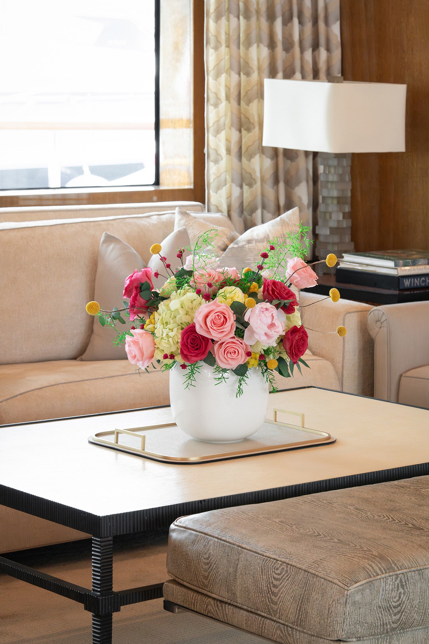 Long lasting preserved arrangement with preserved roses, peonies and hydrangeas in a white vase on board a yacht