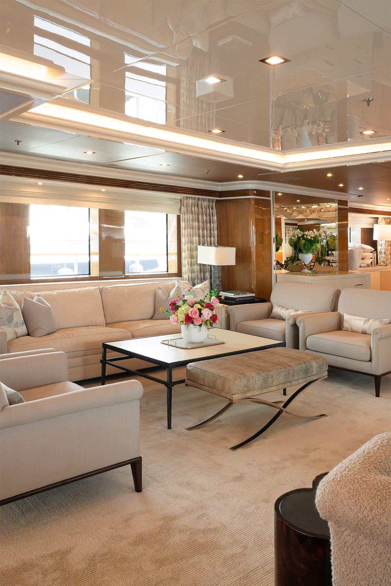 Multicolour preserved arrangement with preserved roses, peonies and hydrangeas in a white vase on board a yacht