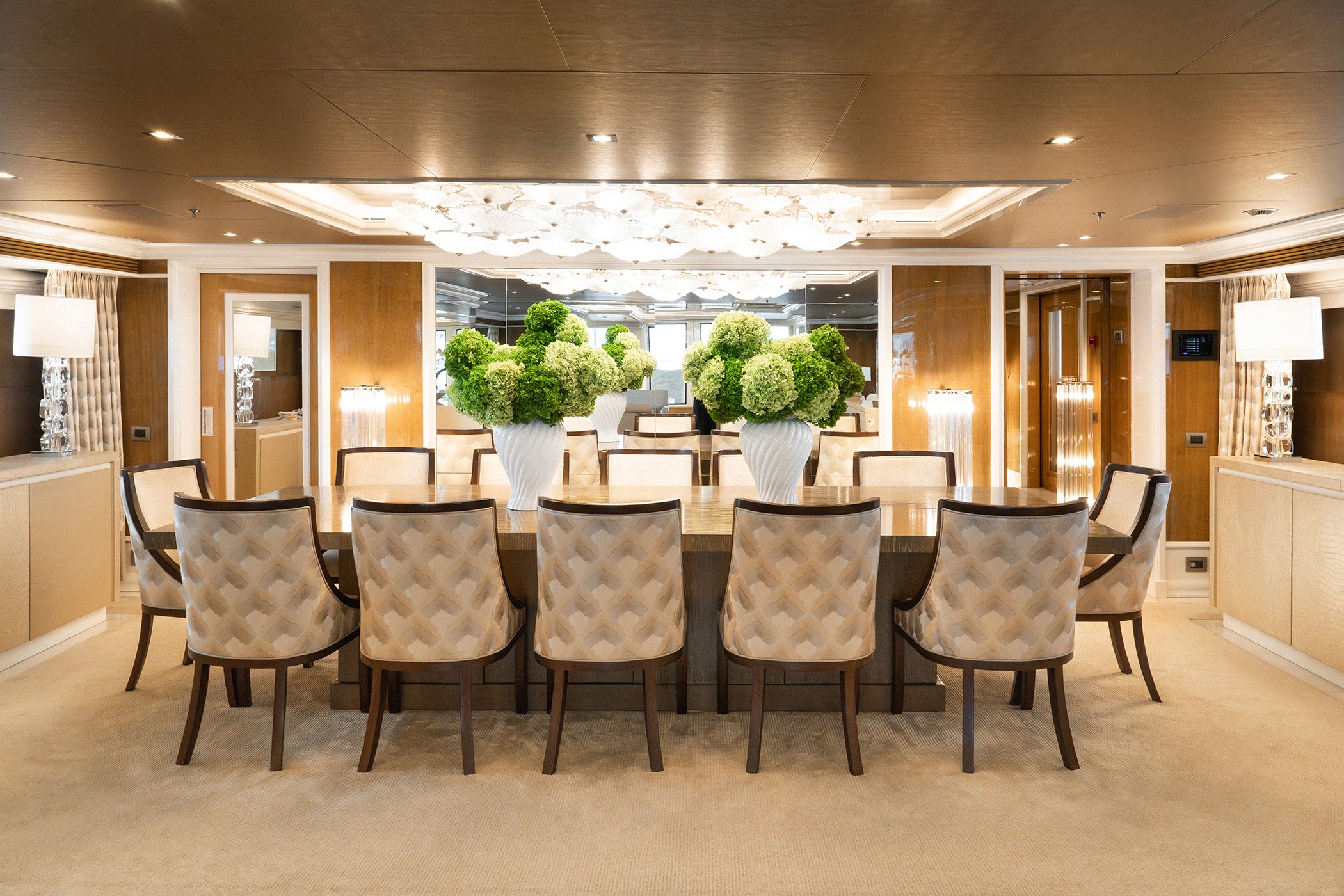 Sculptural preserved hydrangea arrangements in a vase in main dining area on board a yacht