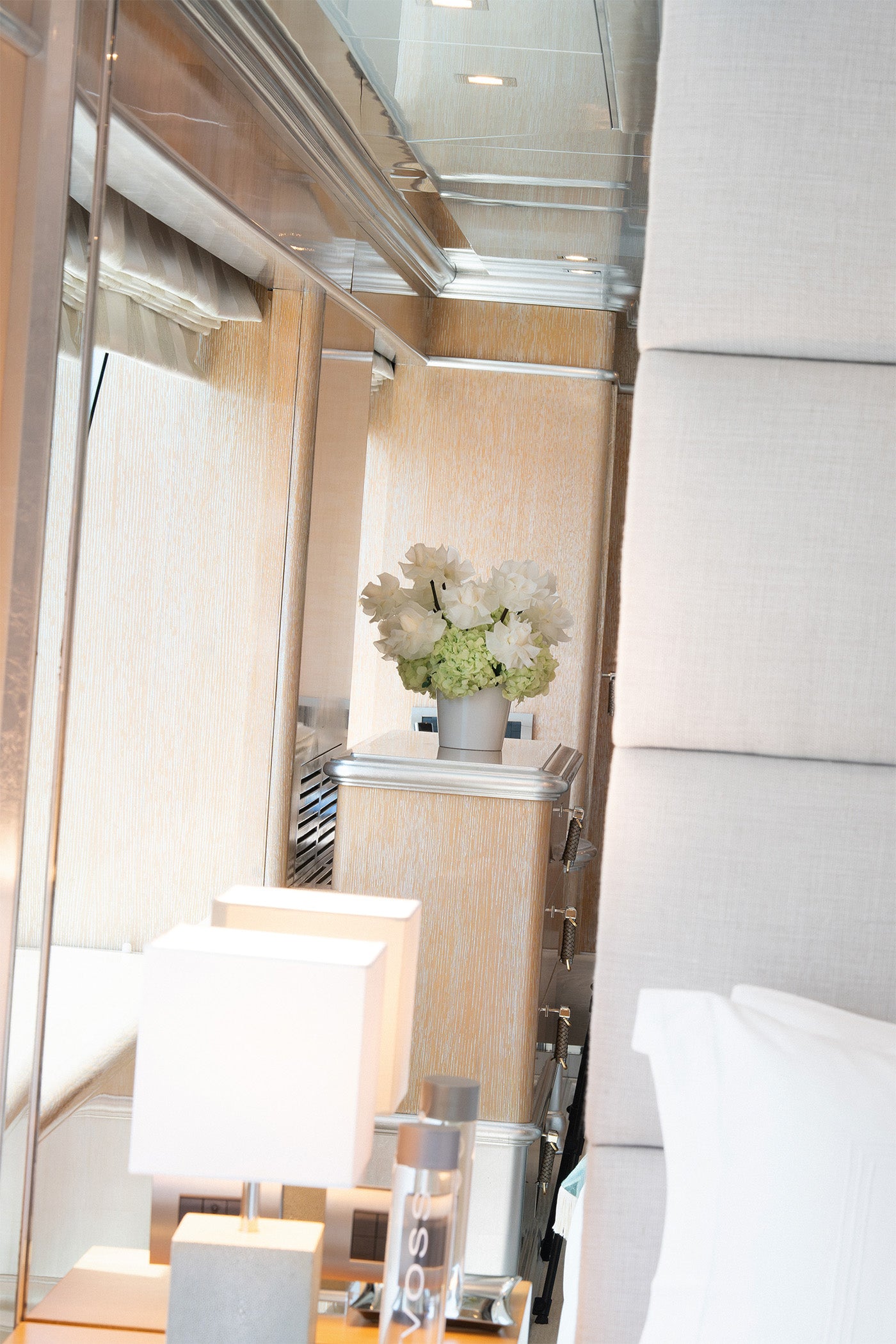Long lasting preserved arrangement with preserved roses and hydrangeas in a white vase on board a yacht