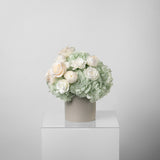 A preserved green hydrangea, gardenia and rose arrangement