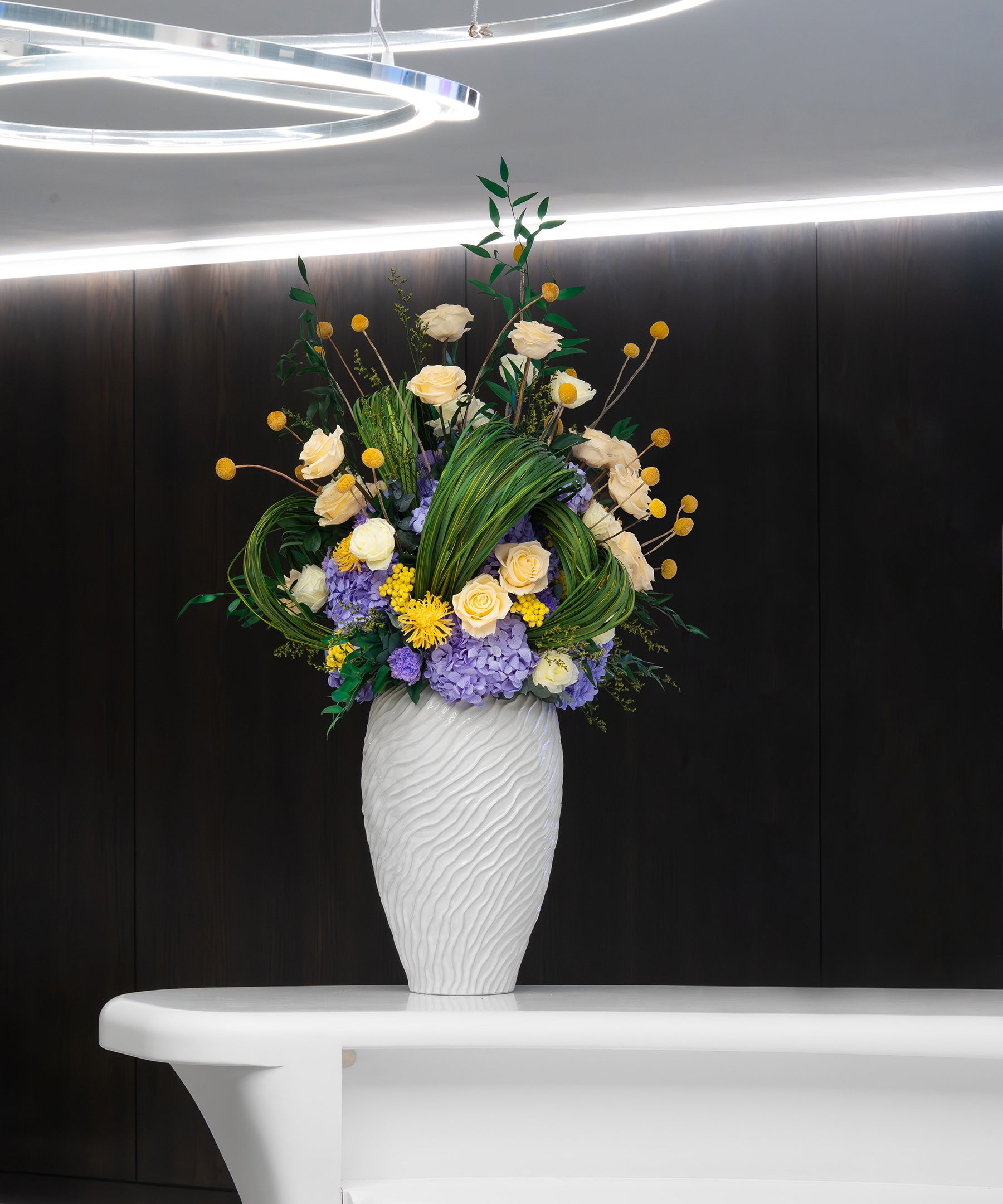 Preserved yellow roses and preserved lilac hydrangeas in office 
