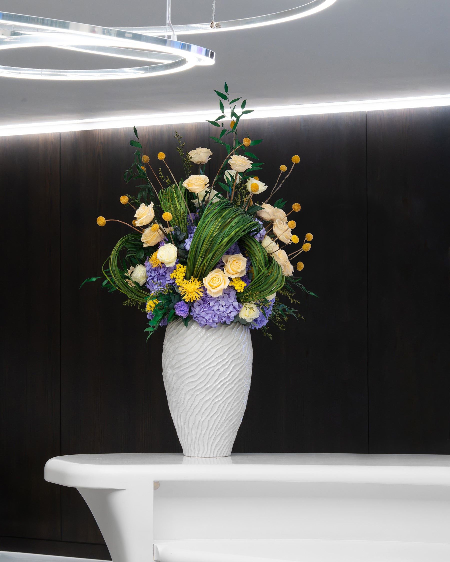 Preserved yellow roses and preserved lilac hydrangeas in office 
