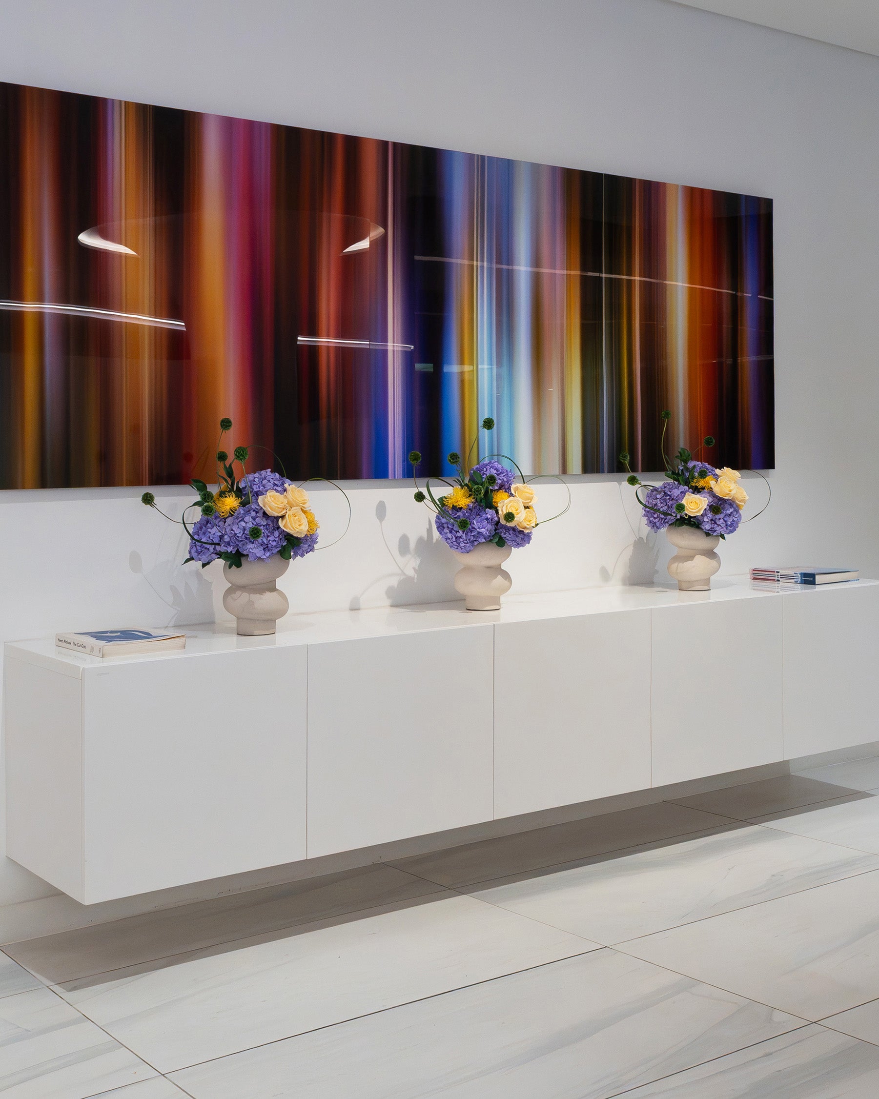 Preserved purple and yellow flowers in office.