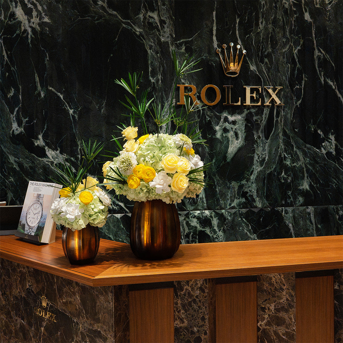 Two preserved Ethereal Blooms arrangements for the Rolex Bond Street Store. Featuring preserved green hydrangeas, preserved roses, gardenias, dahlias and ranunculus, finished with papyrus.