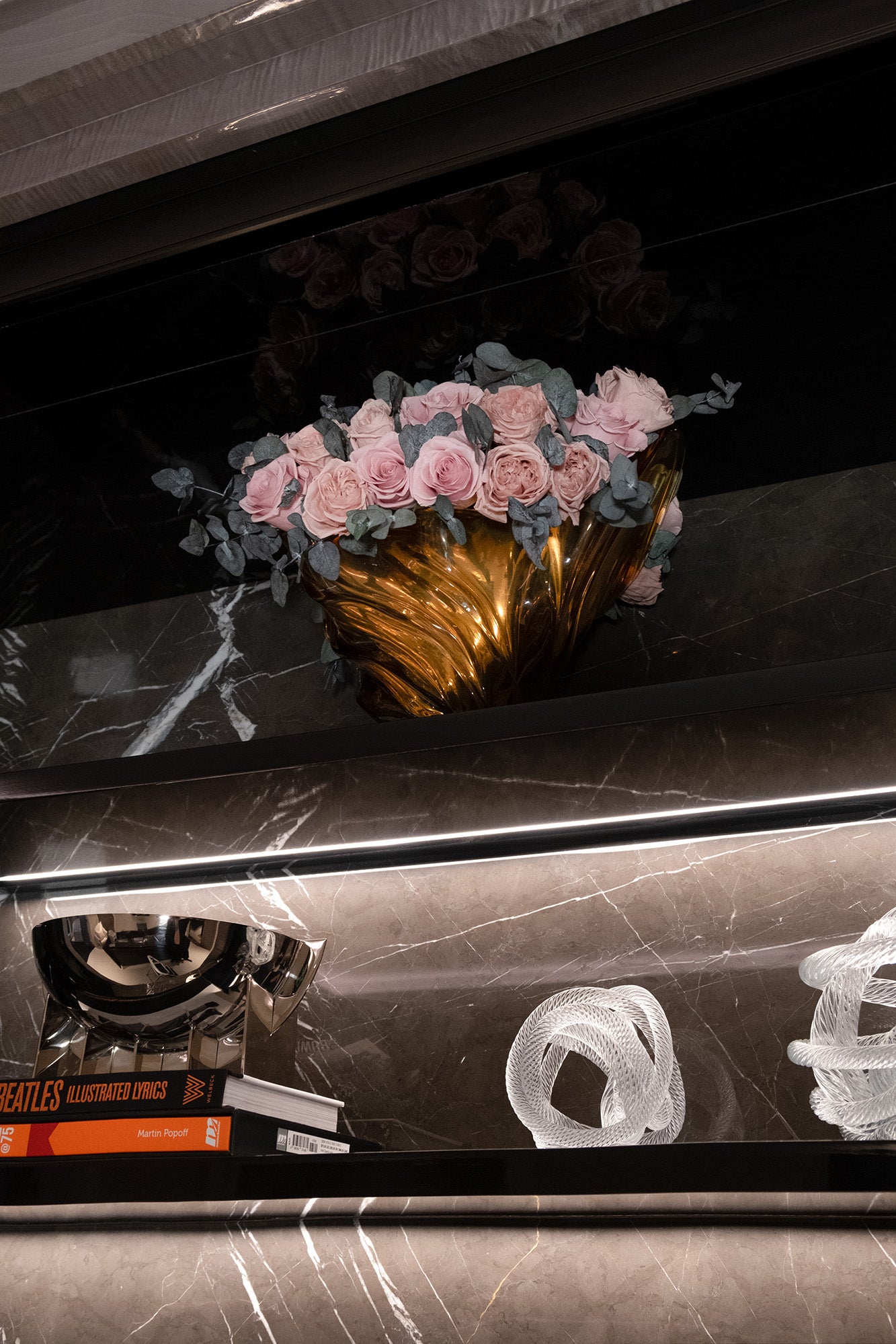 Decorative vase with preserved pink roses on a marble surface