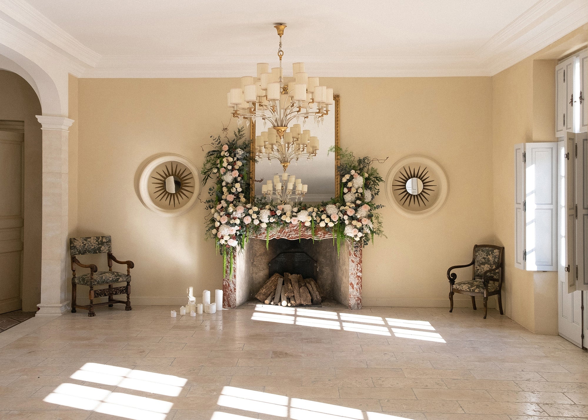 Elegant room with a fireplace decorated with preserved mixed flowers.