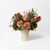Bouquet of toffee and green mix preserved flowers in a ceramic vase on a white background