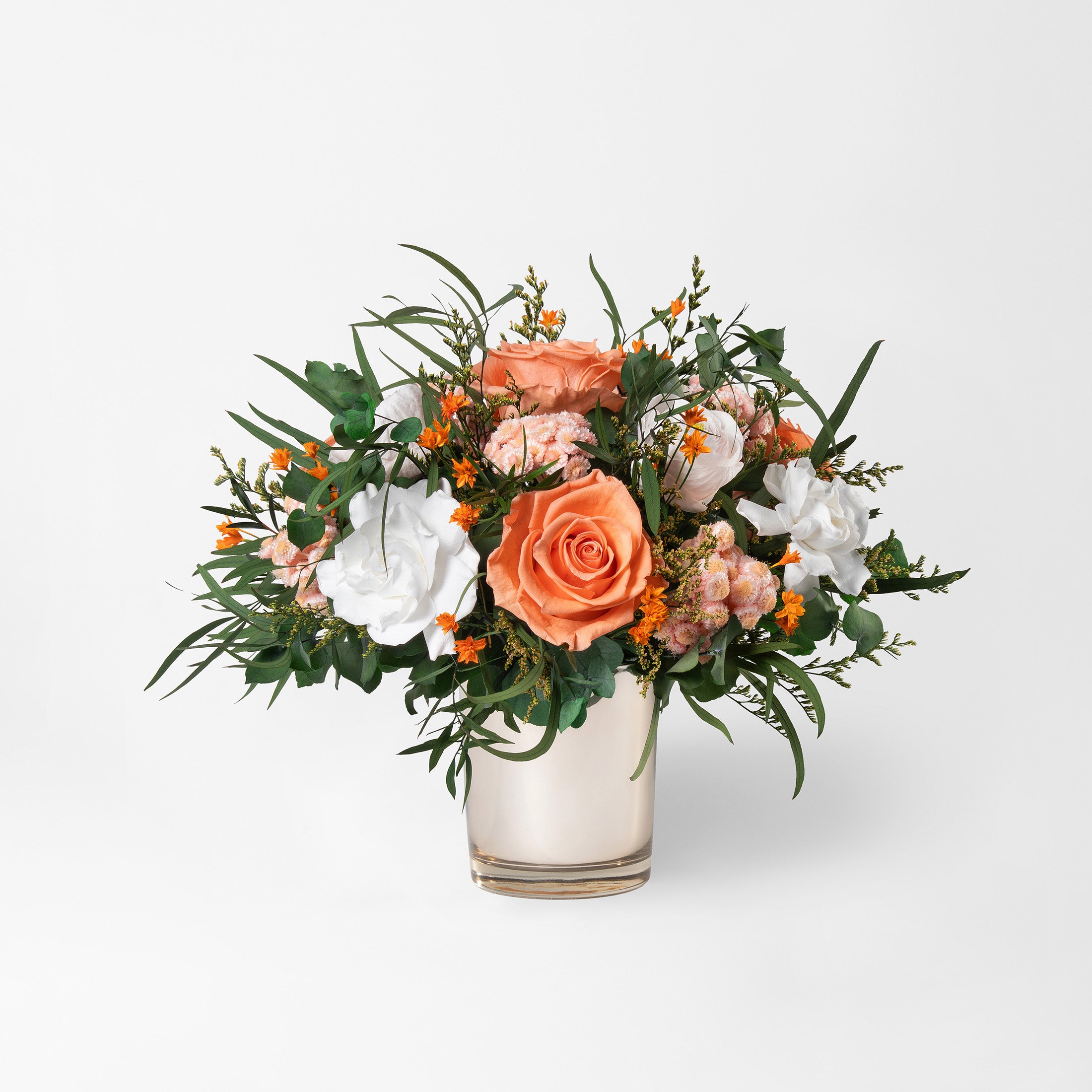 Preserved bouquet of orange and white flowers in a gold glass vase 