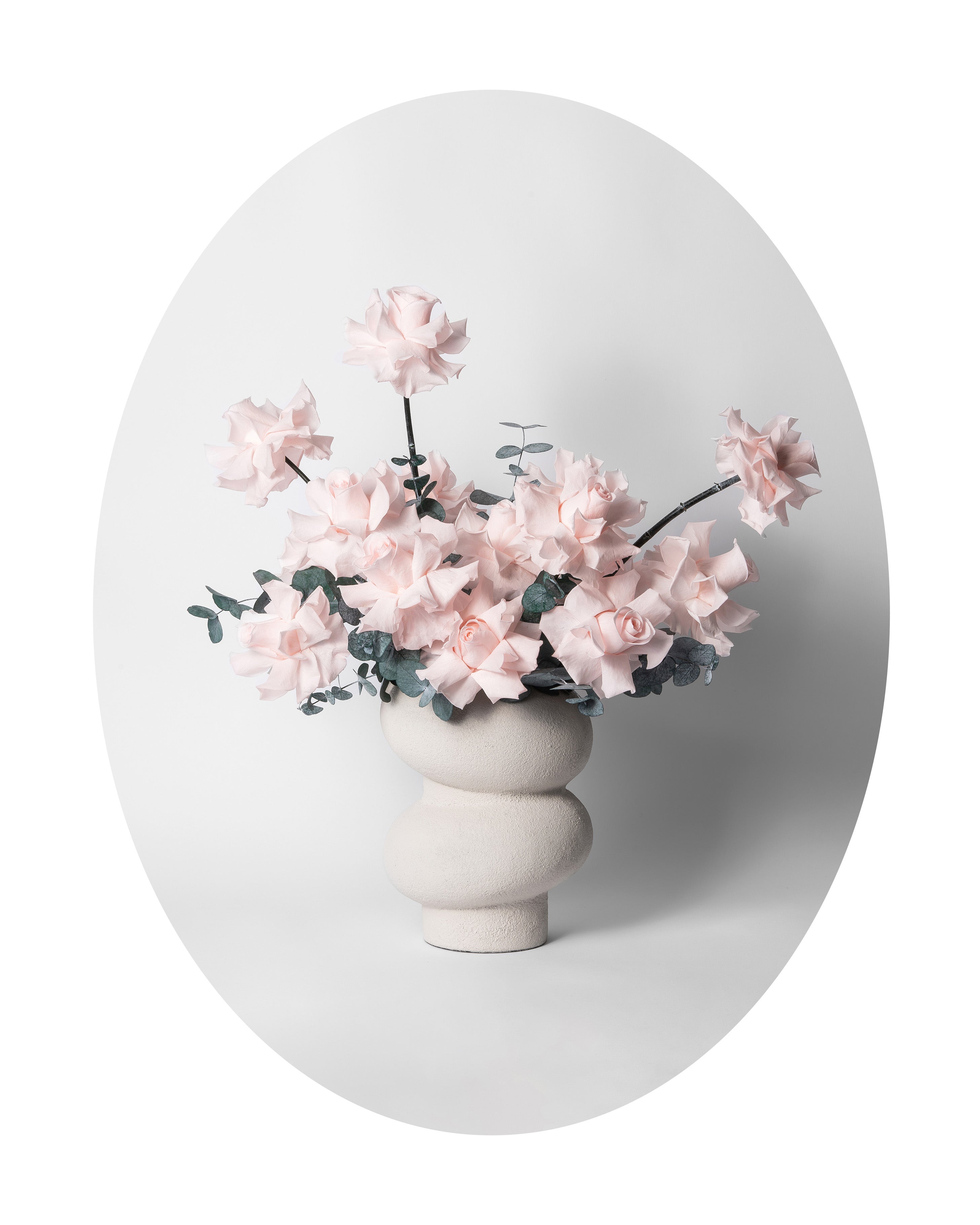 Preserved reflexed roses with eucalyptus in a modern vase