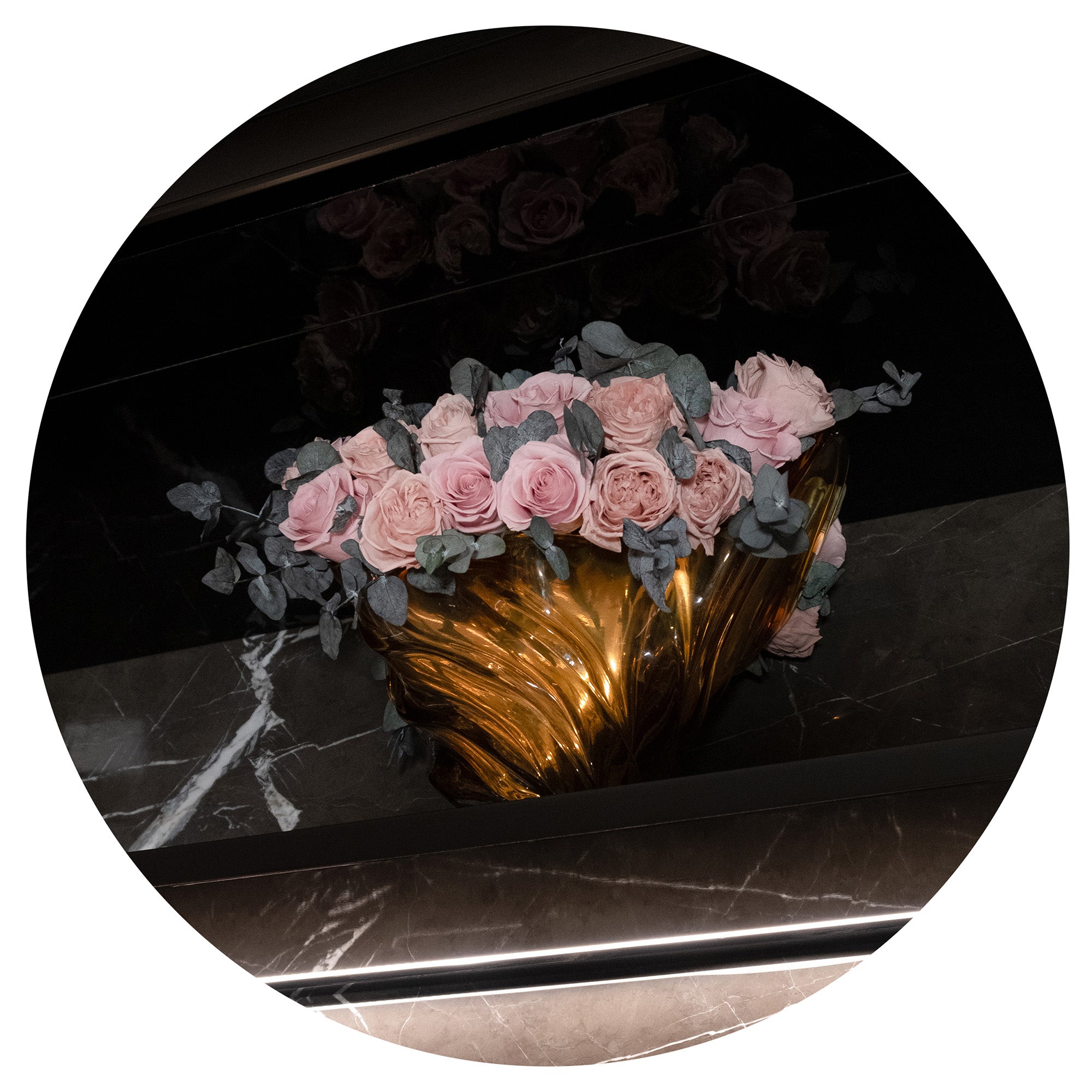 Preserved rose arrangement with eucalyptus on marble shelf