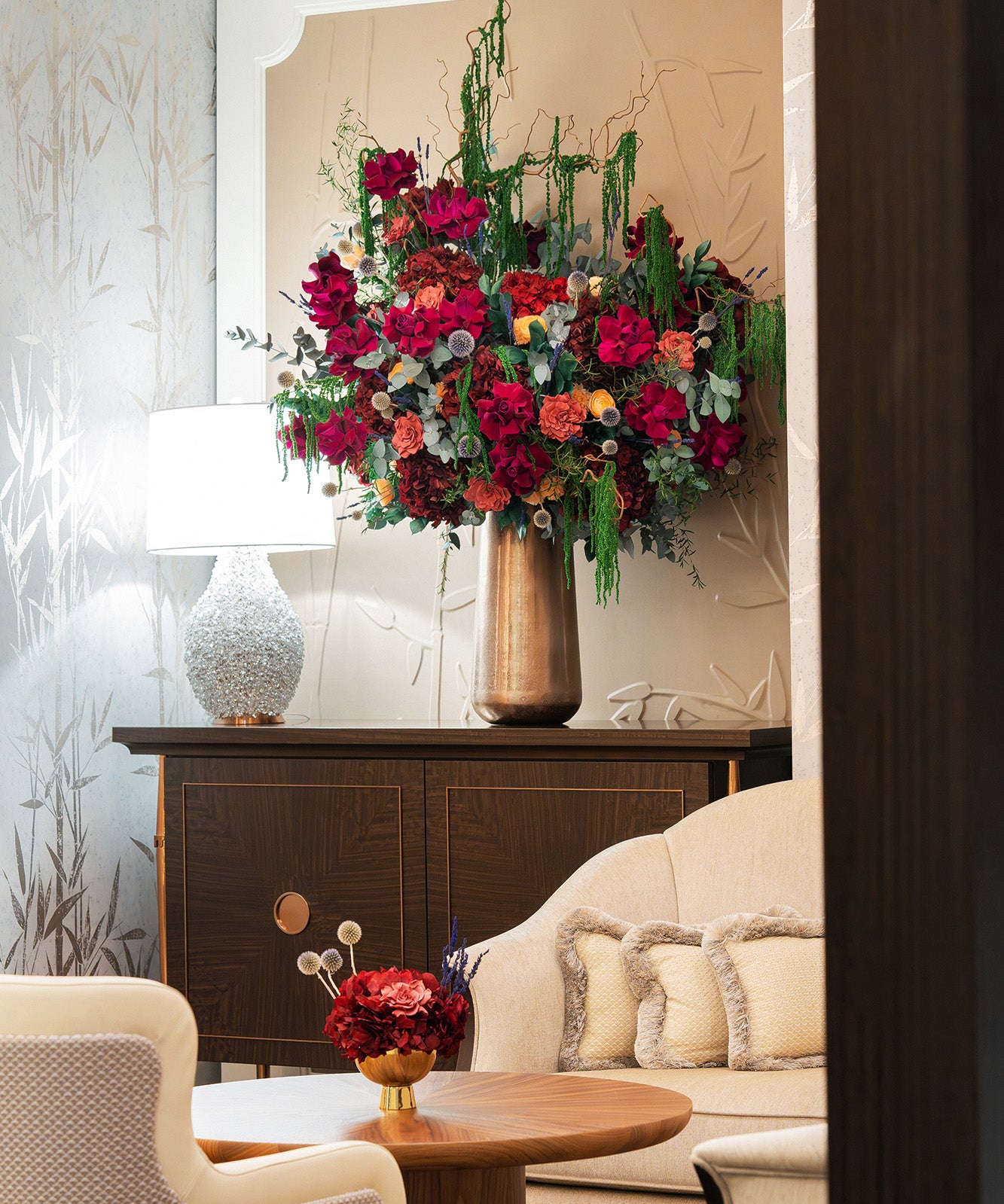 Large preserved mixed flower arrangement and a small preserved hydrangea bouquet in a bar lobby