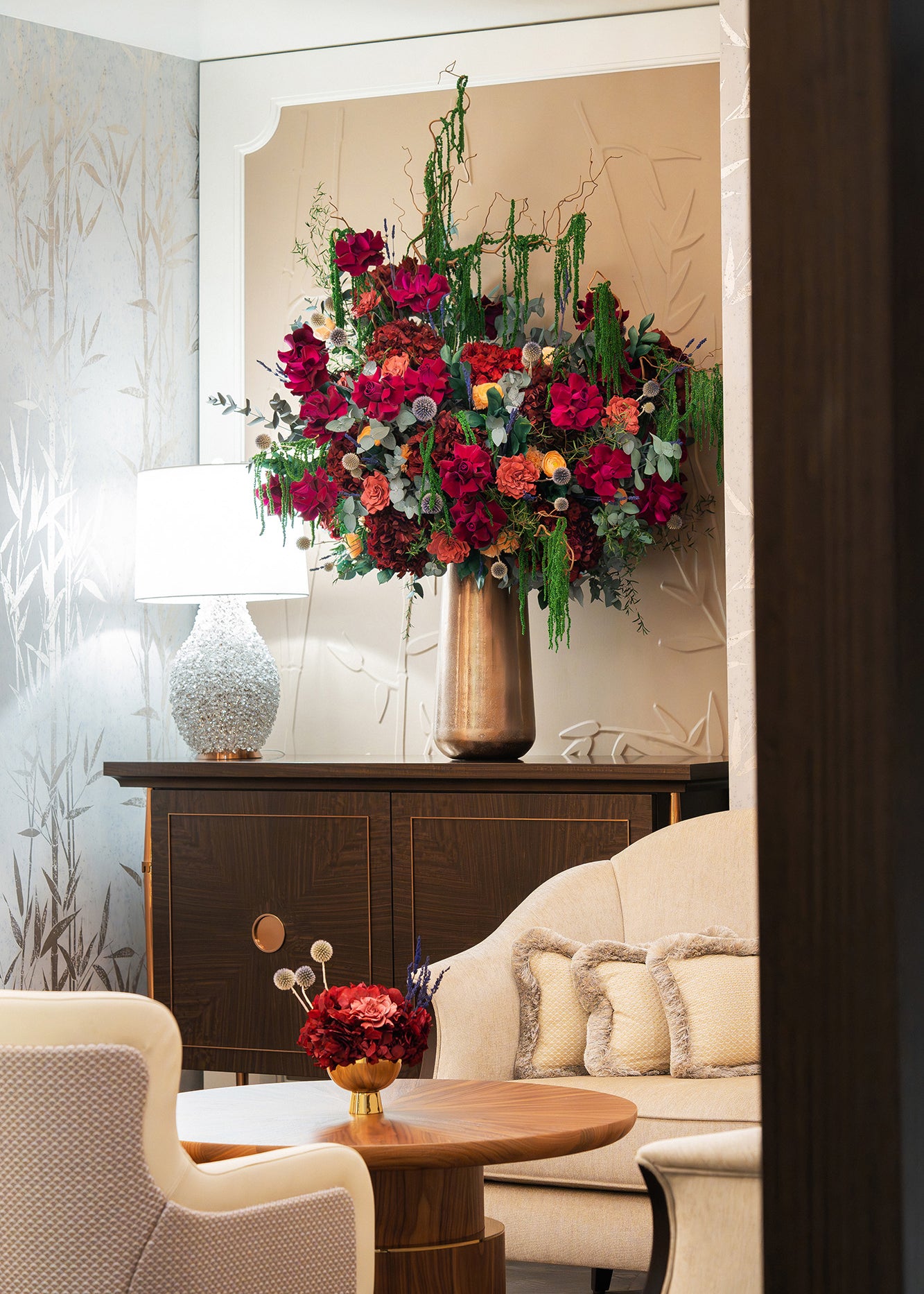 Large preserved mixed flower arrangement and a small preserved hydrangea bouquet in a bar lobby