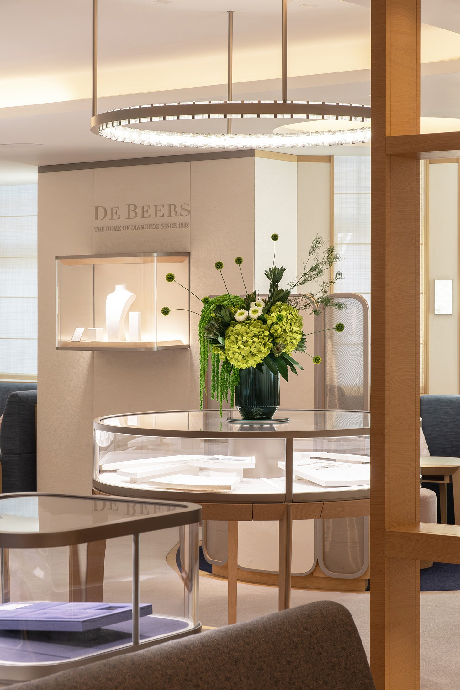 Preserved green hydrangea, chrysanthemum, scabiosa and amaranth arrangement displayed in a luxury store