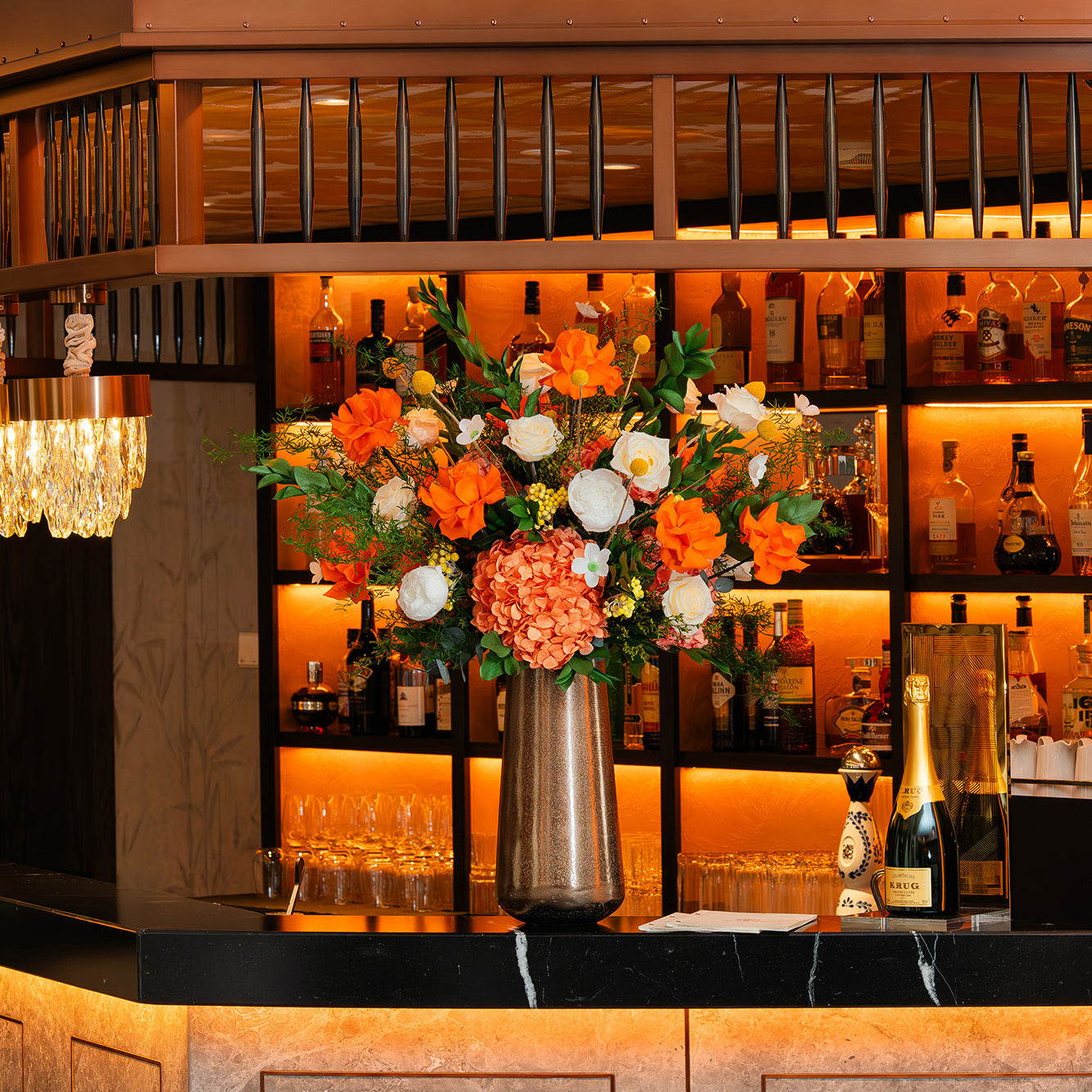 Preserved mixed flower arrangement on a hotel bar counter