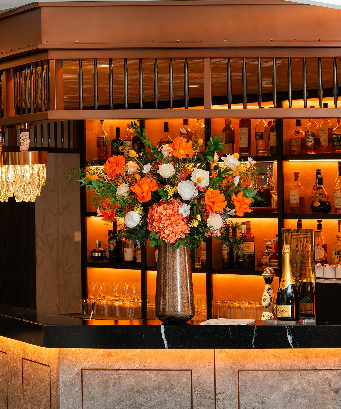 Preserved mixed flower arrangement on a hotel bar counter