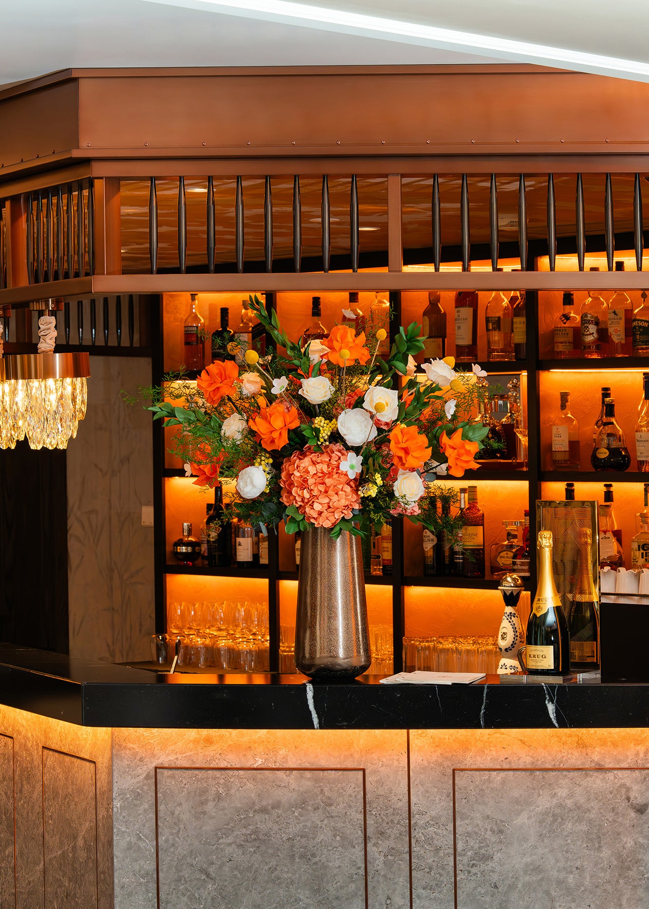 Preserved mixed flower arrangement on a hotel bar counter