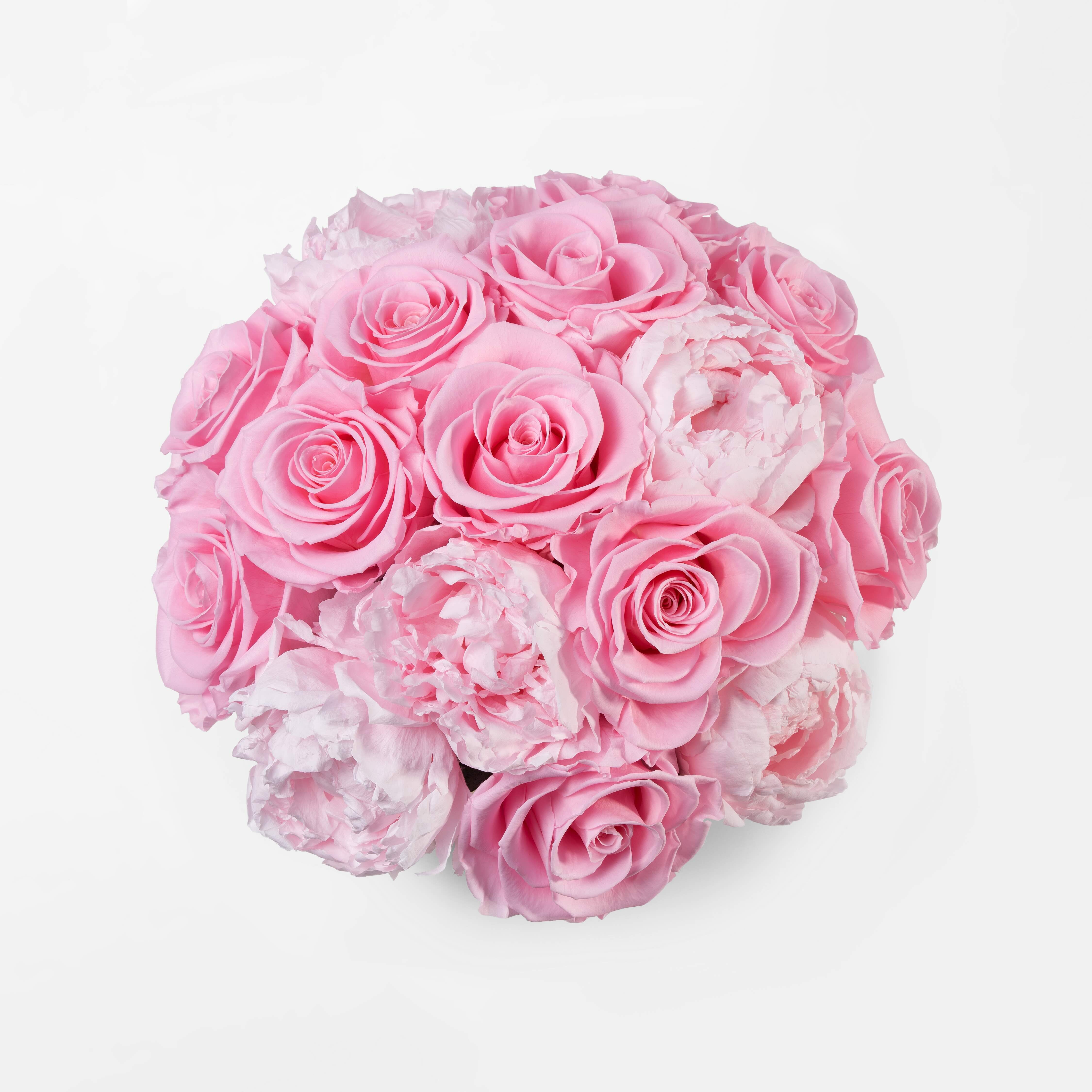 Gold vase with preserved pink roses and peonies