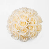 Gold vase with preserved white roses