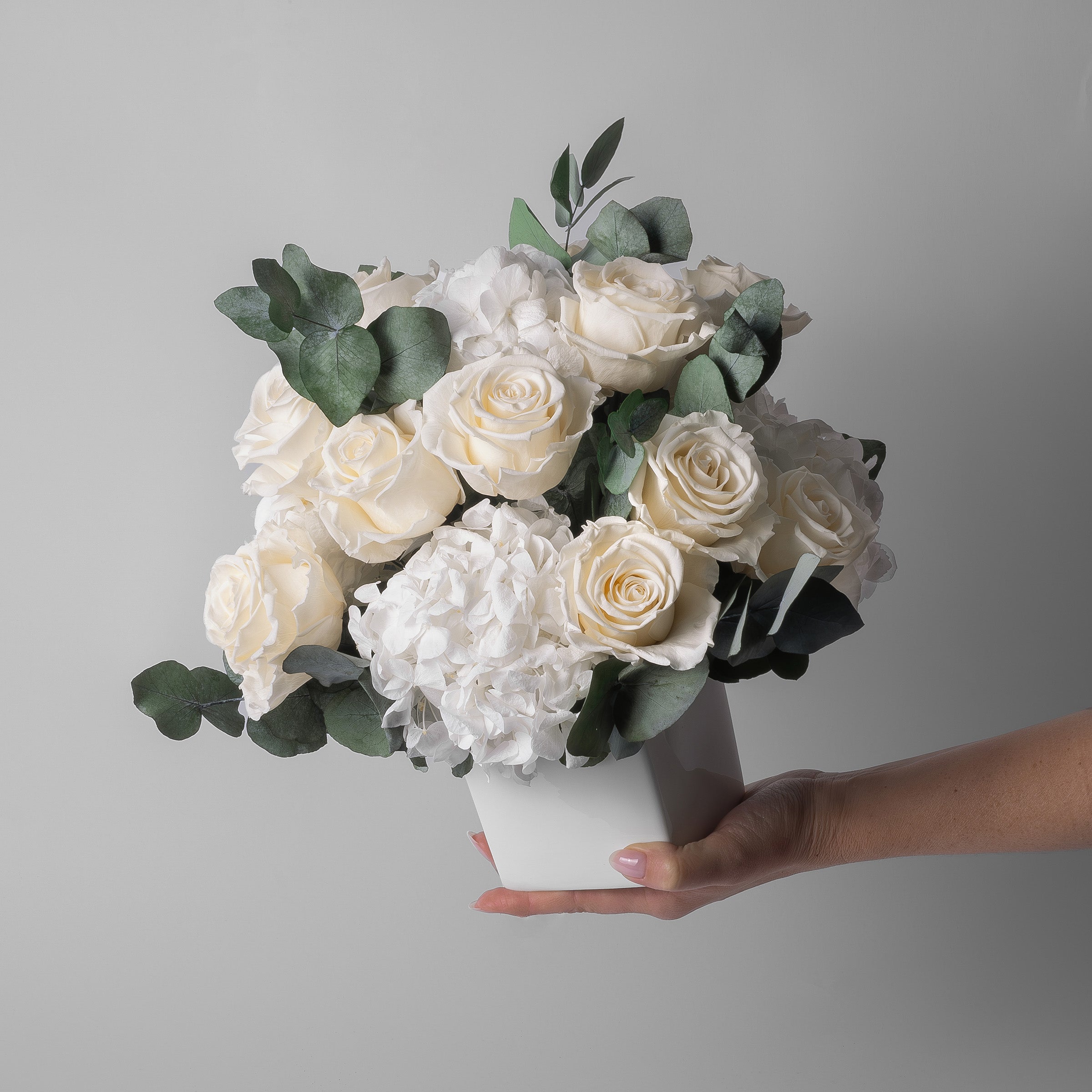 PRESERVED WHITE ROSE AND HYDRANGEA ARRANGEMENT IN WHITE CUBE VASE