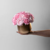 Gold vase with preserved pink roses and peonies
