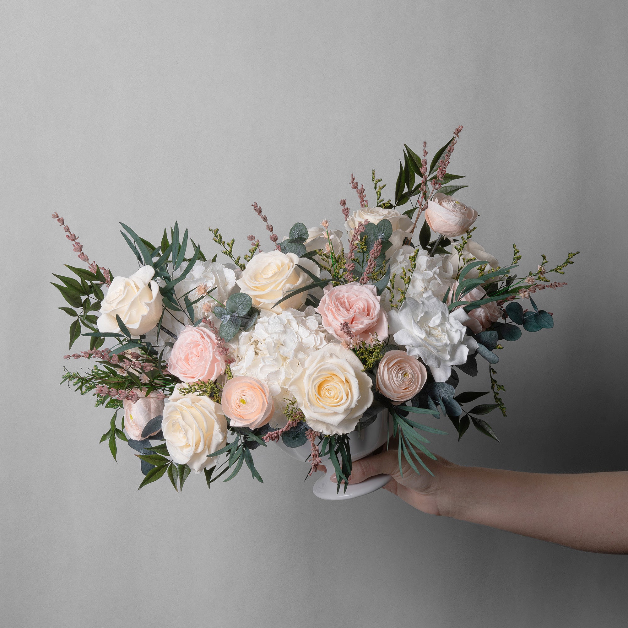 PRESERVED BLUSH AND WHITE MIXED FLOWER ARRANGEMENT IN WHITE CERAMIC VASE