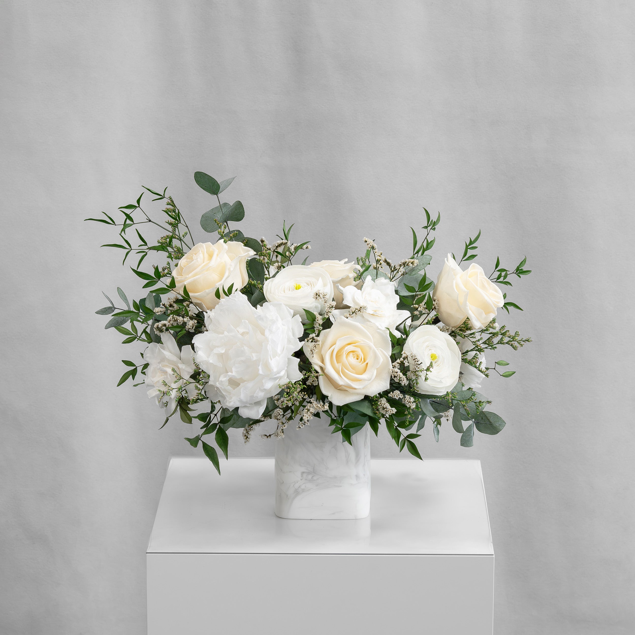 PRESERVED WHITE MIXED FLOWER ARRANGEMENT IN MARBLE VASE
