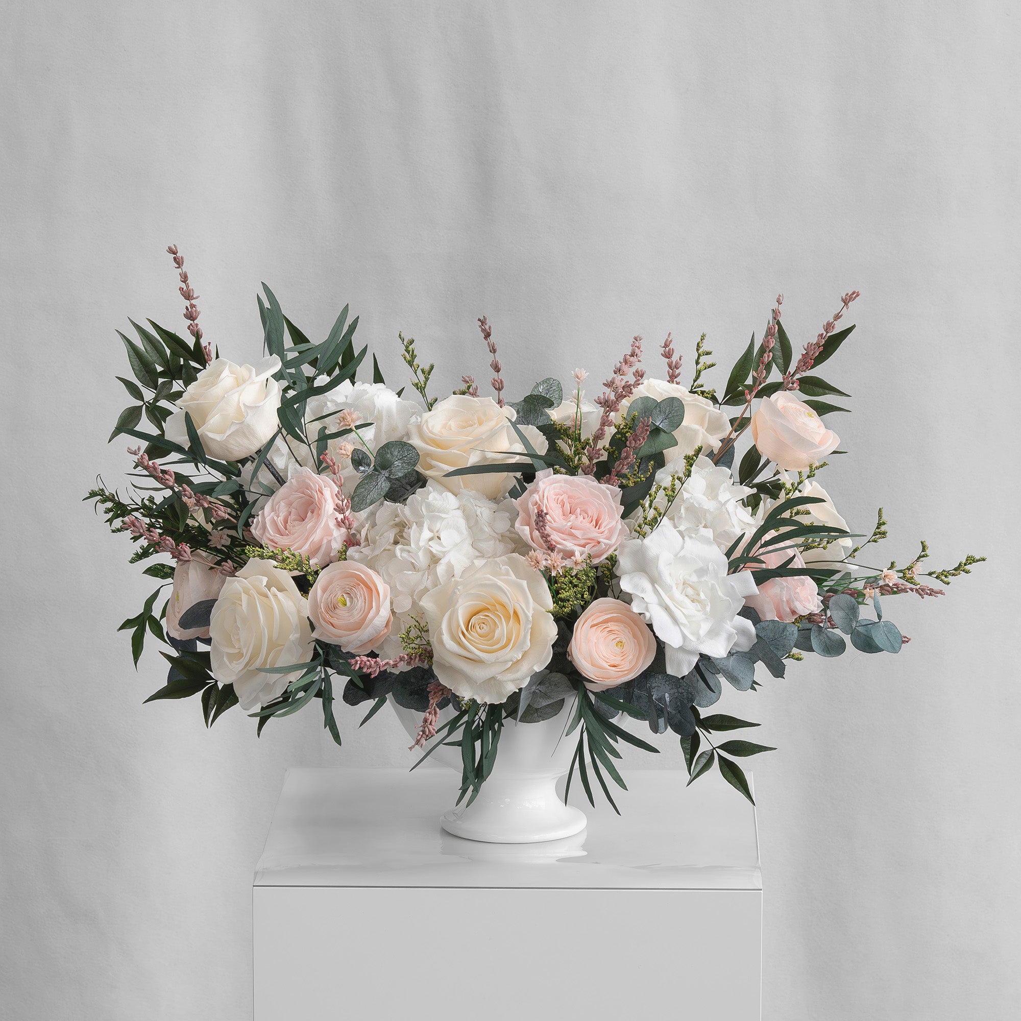 PRESERVED BLUSH AND WHITE MIXED FLOWER ARRANGEMENT IN WHITE CERAMIC VASE
