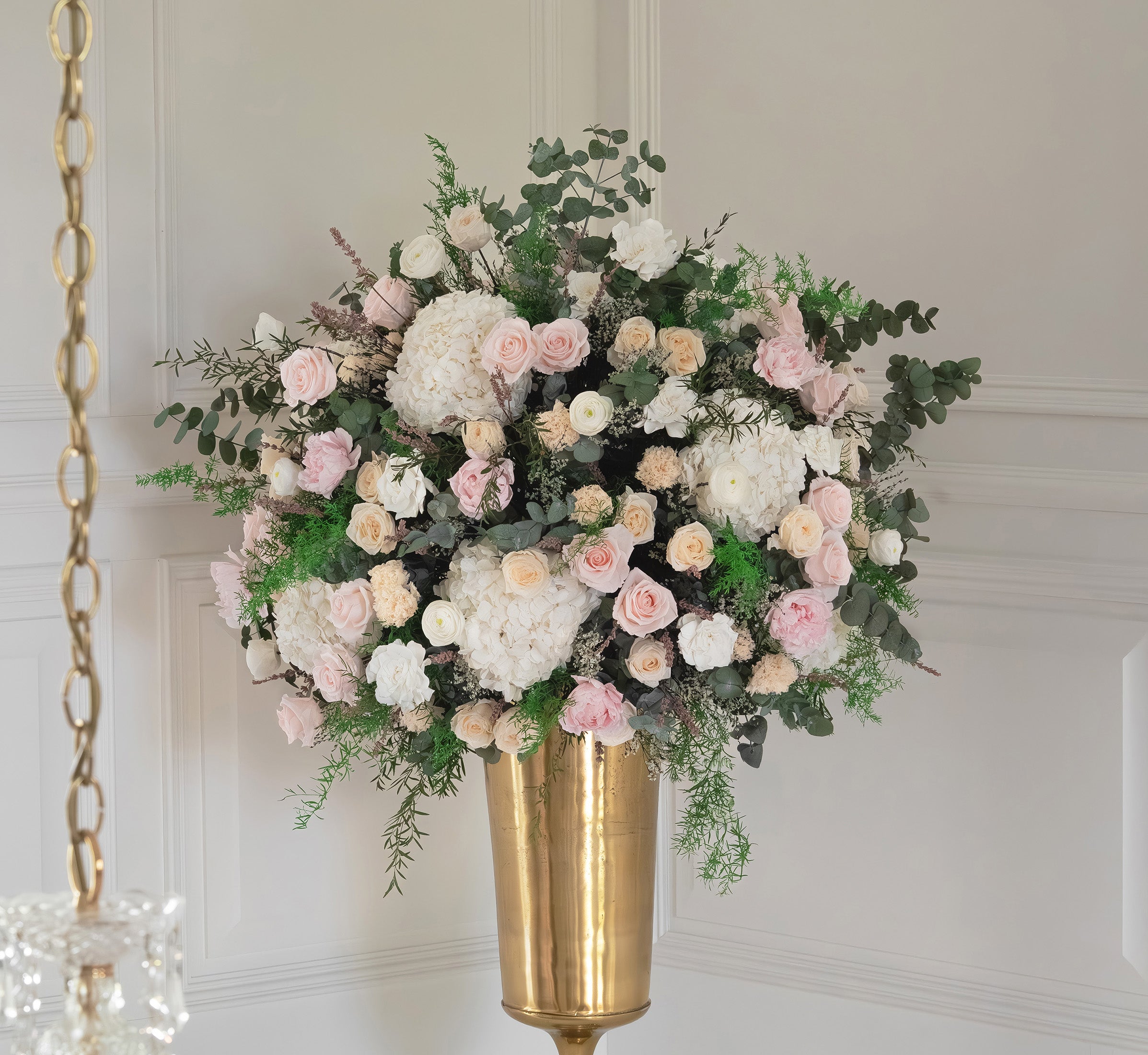 Preserved mixed flower arrangement in gold vase